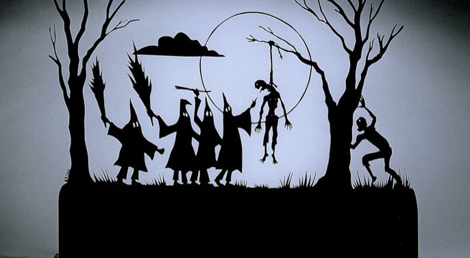 Silhouette of a body hanging surrounded by hooded figures