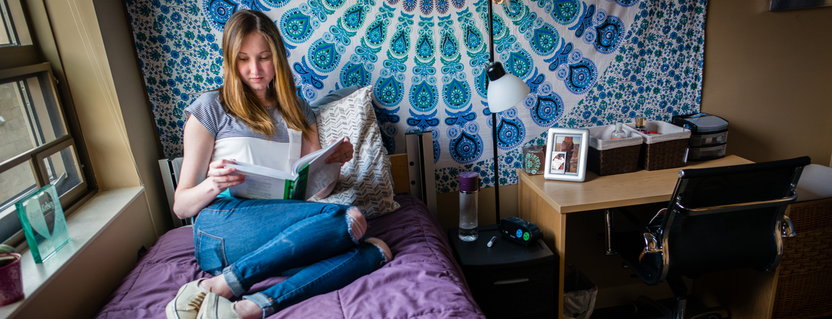 Student studying in a 318 Commons apartment