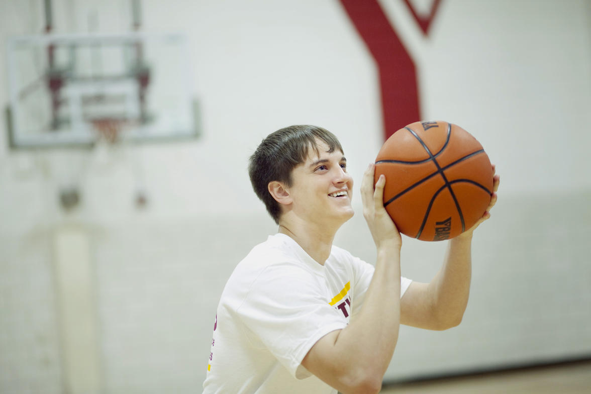 A University of Minnesota Rochester student holding a basketball.