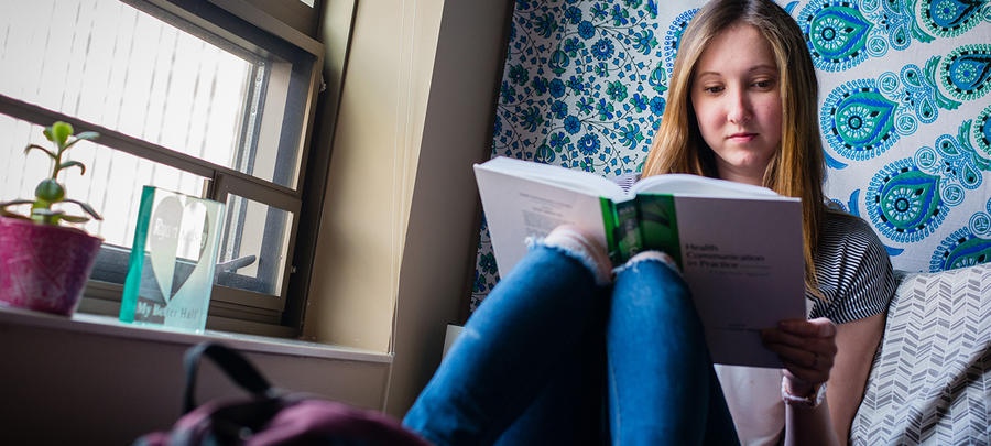 UMR student reading in her dorm room